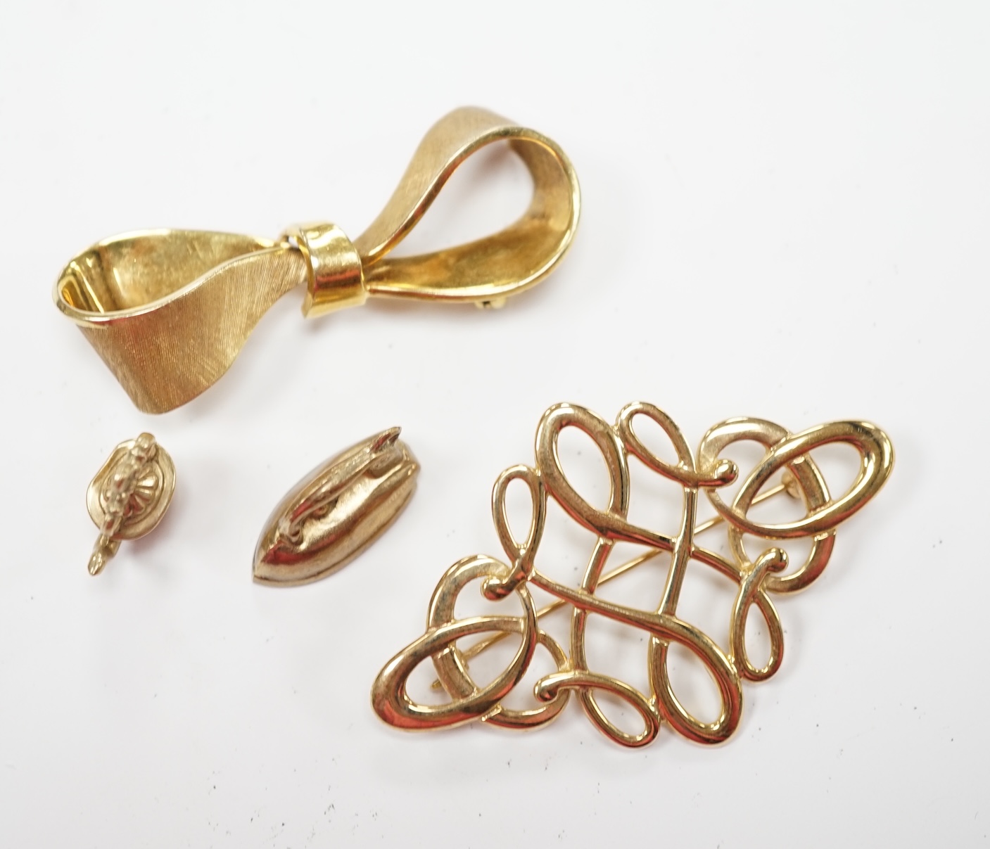 Two modern 9ct gold brooches, including ribbon bow, 45mm and two 9ct gold charms, 12.5 grams. Fair condition.